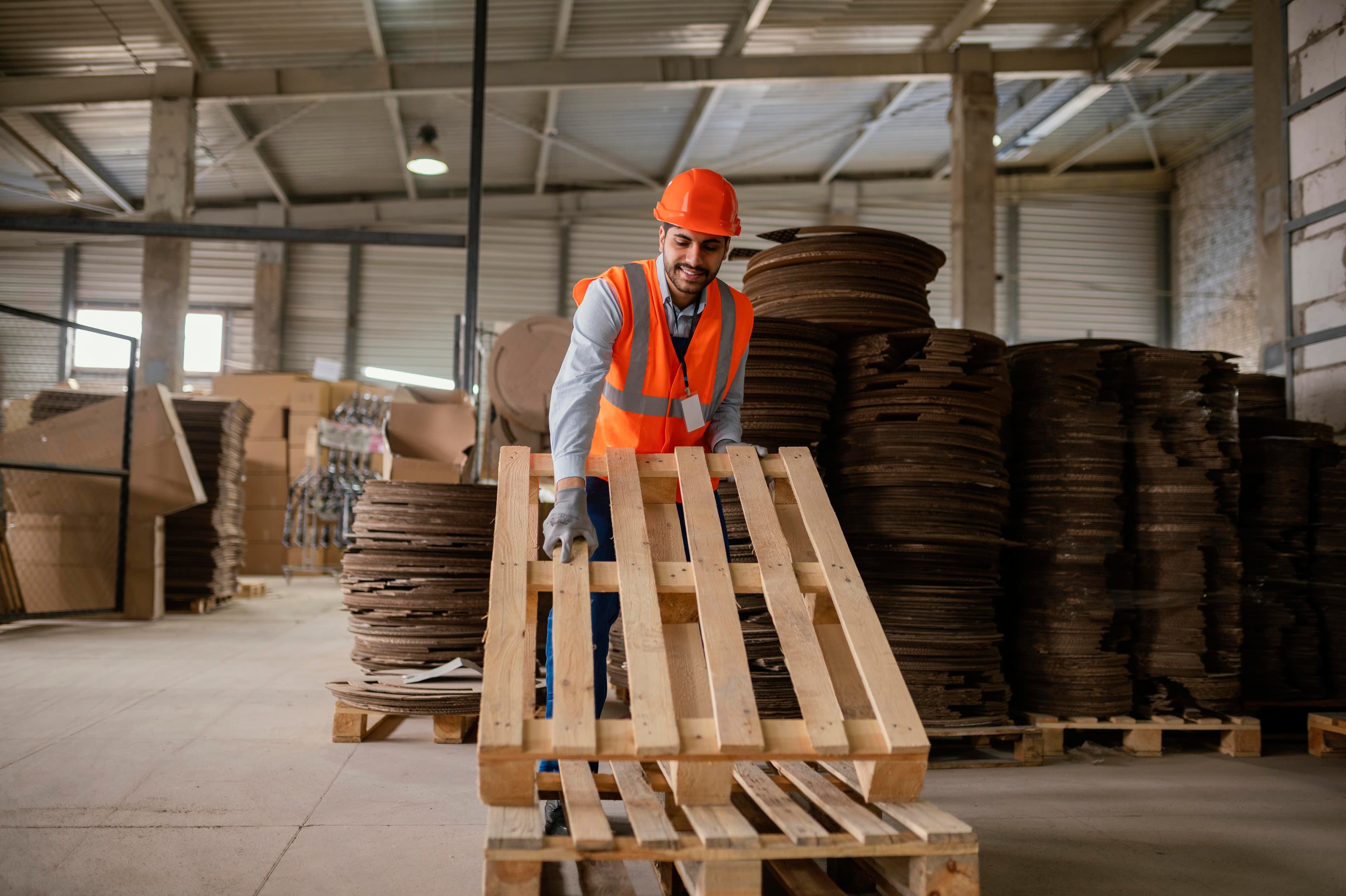 Worker at a pallet operation handling lumber materials